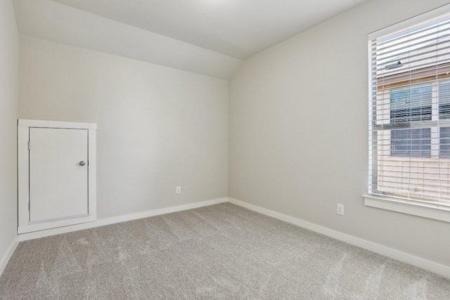 2001 Faro Dr Unit 29, Austin, TX 78741 - empty room featuring a healthy amount of sunlight, carpet floors, baseboards, and lofted ceiling
