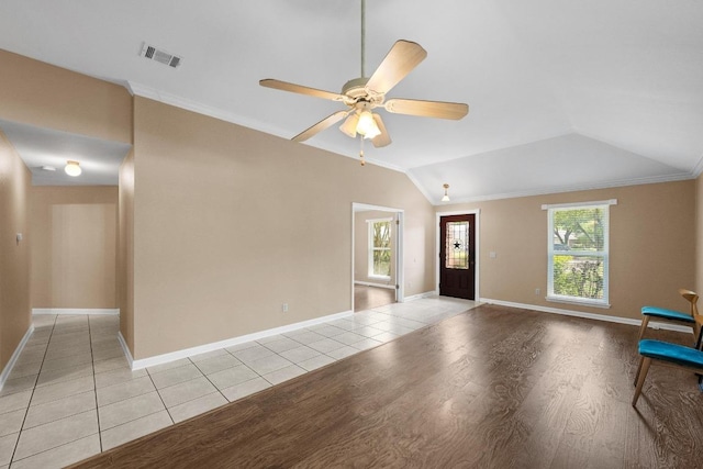 interior space featuring baseboards, a ceiling fan, light wood-type flooring, and visible vents