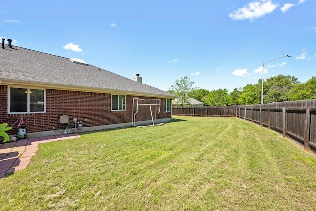 view of yard with a fenced backyard