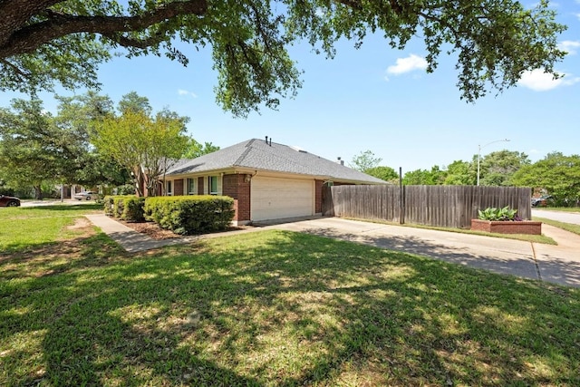 view of side of home featuring fence, brick siding, a garage, concrete driveway, and a lawn