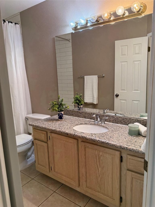 full bath with toilet, tile patterned flooring, and vanity