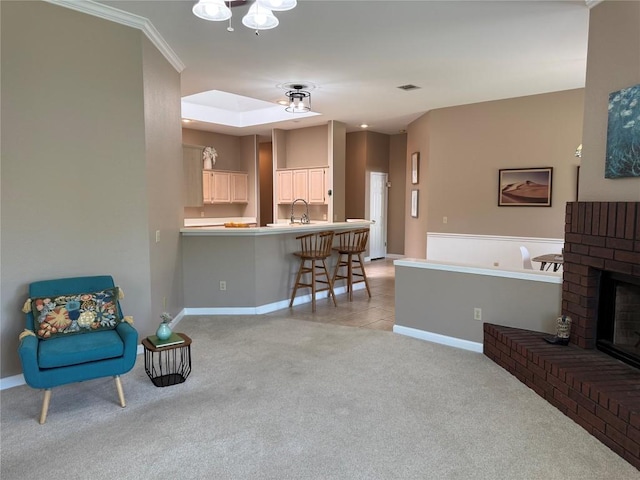 living area with light colored carpet, baseboards, light tile patterned floors, and a fireplace
