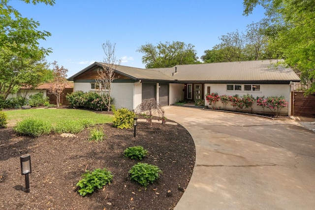 1803 Cedar Ridge Dr, Austin, TX 78741 - single story home featuring a garage, driveway, and metal roof