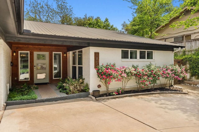 1803 Cedar Ridge Dr, Austin, TX 78741 - entrance to property featuring metal roof and brick siding