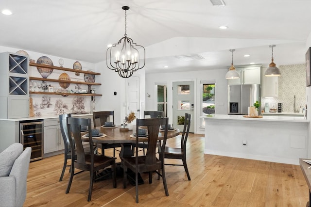 1803 Cedar Ridge Dr, Austin, TX 78741 - dining area featuring wine cooler, lofted ceiling, light wood-style flooring, a bar, and recessed lighting