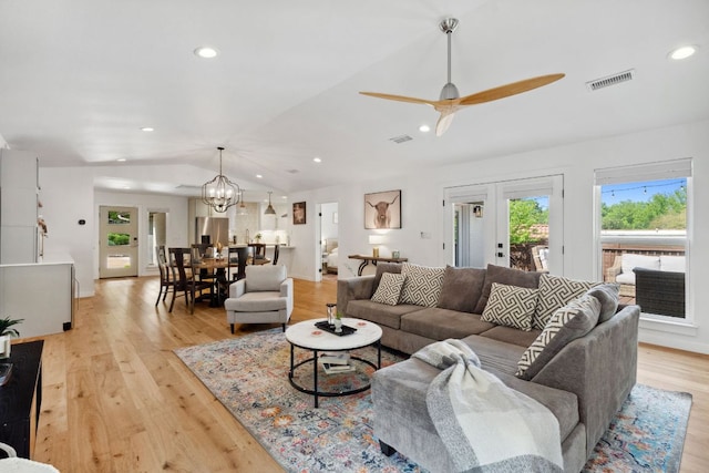 1803 Cedar Ridge Dr, Austin, TX 78741 - living area featuring lofted ceiling, light wood-style floors, ceiling fan, a chandelier, and recessed lighting
