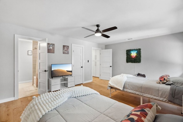 1803 Cedar Ridge Dr, Austin, TX 78741 - bedroom with wood finished floors, baseboards, and a ceiling fan