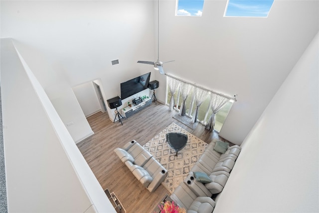 18005 Umberto Dr, Pflugerville, TX 78660 - living area with a high ceiling, wood finished floors, and ceiling fan