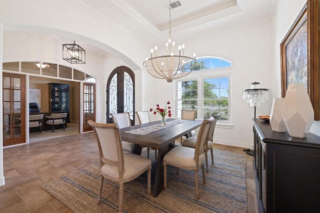 1310 Ventana Cyn, Leander, TX 78641 - dining area featuring french doors, arched walkways, a chandelier, ornamental molding, and a towering ceiling