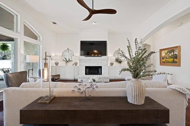 1310 Ventana Cyn, Leander, TX 78641 - living room with crown molding, a ceiling fan, a fireplace, and wood finished floors