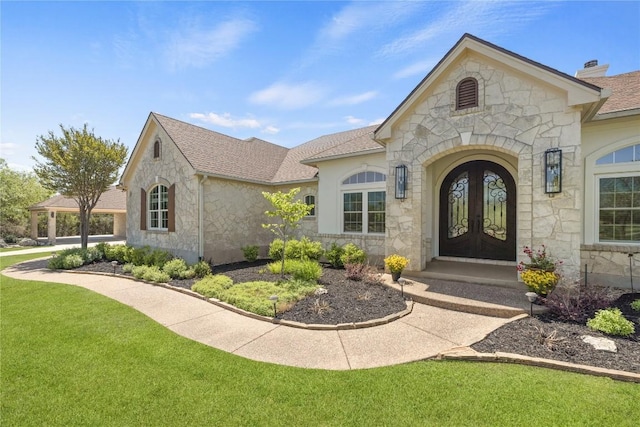 1310 Ventana Cyn, Leander, TX 78641 - doorway to property featuring stone siding, french doors, a lawn, and roof with shingles