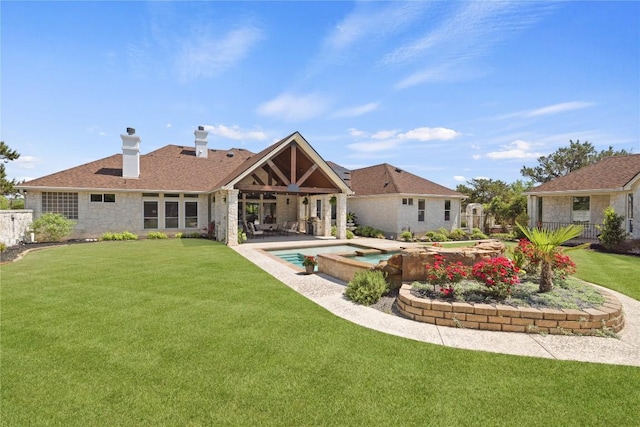1310 Ventana Cyn, Leander, TX 78641 - rear view of property with a chimney, a patio area, stone siding, and a pool with connected hot tub
