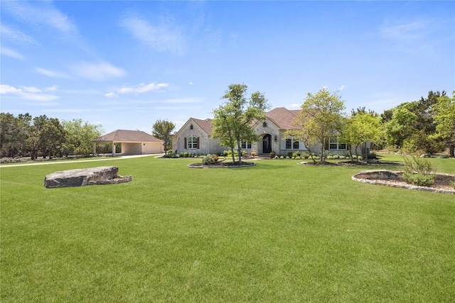 1310 Ventana Cyn, Leander, TX 78641 - view of grassy yard with a garage and driveway