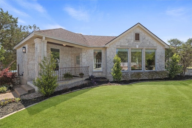 1310 Ventana Cyn, Leander, TX 78641 - view of front of house featuring stone siding, a shingled roof, and a front yard