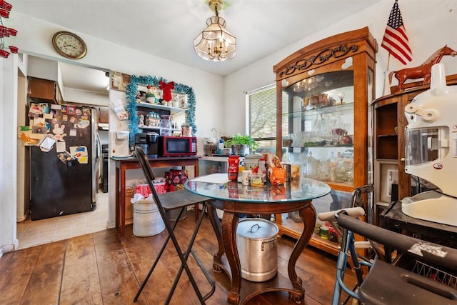 dining space with wood-type flooring and a notable chandelier
