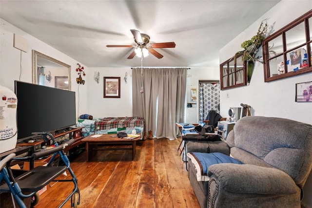 living area featuring hardwood / wood-style floors and ceiling fan