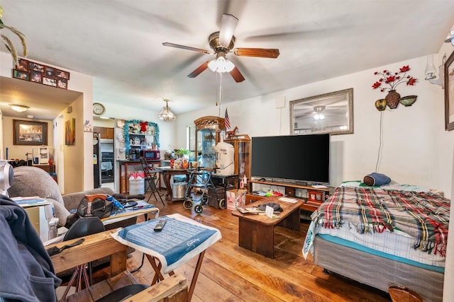 living area featuring a ceiling fan and hardwood / wood-style flooring