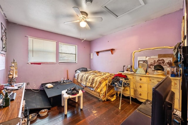 bedroom featuring wood-type flooring, ceiling fan, and attic access