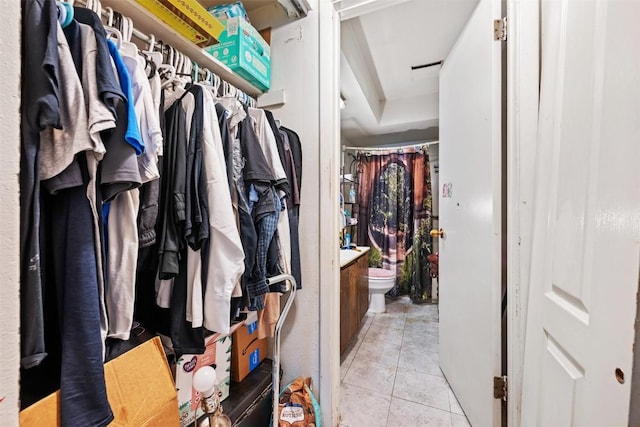 spacious closet with light tile patterned flooring