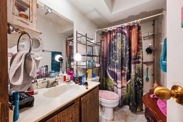 bathroom featuring toilet, curtained shower, vanity, and tile patterned flooring