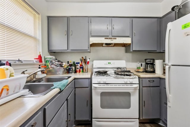 kitchen featuring gray cabinets, white appliances, and under cabinet range hood