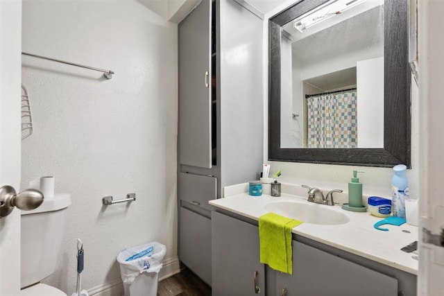 825 Ken St, Austin, TX 78758 - full bath featuring a shower with shower curtain, toilet, wood finished floors, and vanity
