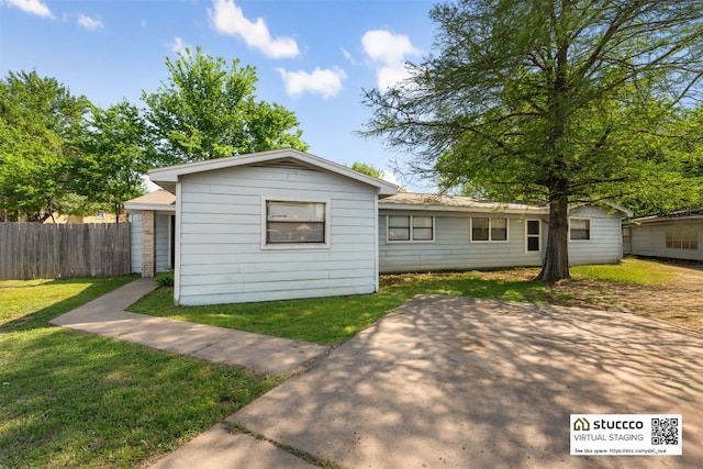 825 Ken St, Austin, TX 78758 - view of front of house with fence, a patio area, and a front yard