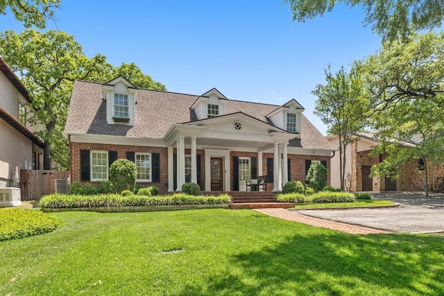 1307 Elton Ln, Austin, TX 78703 - cape cod home with brick siding, a porch, and roof with shingles