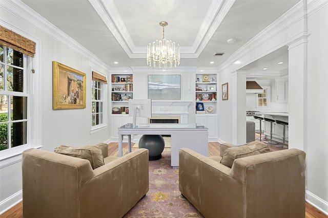 1307 Elton Ln, Austin, TX 78703 - living room featuring ornamental molding, built in features, a chandelier, a fireplace, and wood finished floors