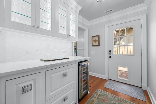 1307 Elton Ln, Austin, TX 78703 - indoor bar with beverage cooler, dark wood-type flooring, and crown molding