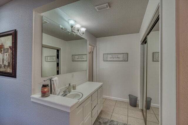 605 Port Unit 3, Horseshoe Bay, TX 78657 - bathroom featuring vanity, a textured ceiling, tile patterned flooring, and baseboards