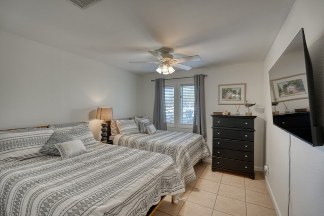 605 Port Unit 3, Horseshoe Bay, TX 78657 - bedroom featuring light tile patterned flooring, a ceiling fan, and baseboards