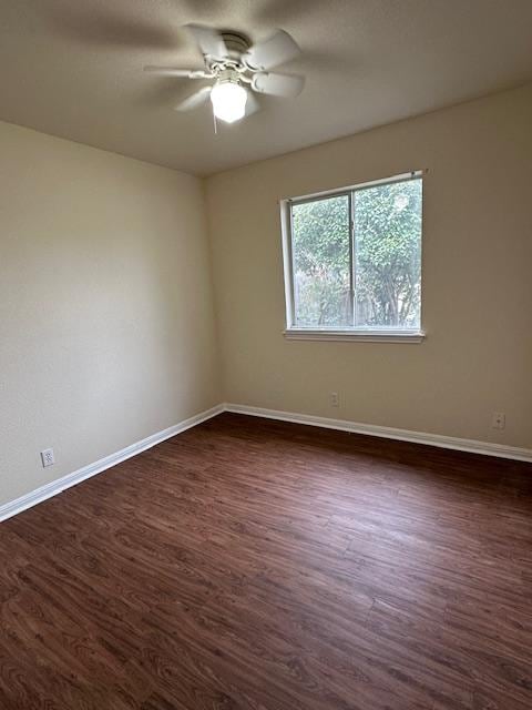 377 Donatello, Kyle, TX 78640 - unfurnished room with a ceiling fan and dark wood-style floors