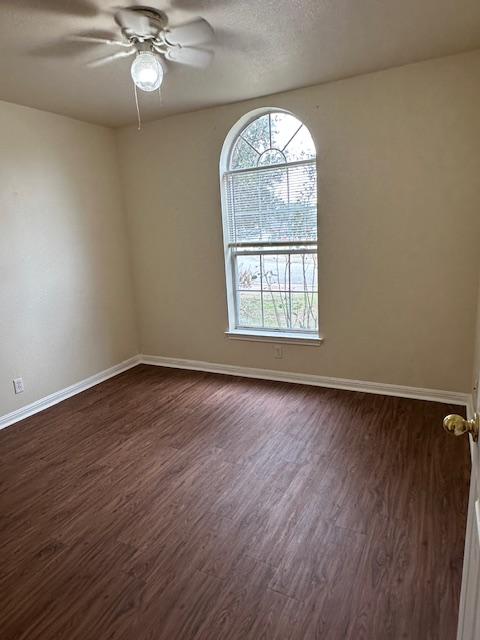 377 Donatello, Kyle, TX 78640 - spare room featuring dark wood-style floors and a ceiling fan