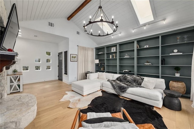 5224 Mccormick Mountain Dr, Austin, TX 78734 - living room with wood finished floors, a chandelier, high vaulted ceiling, baseboards, and a skylight