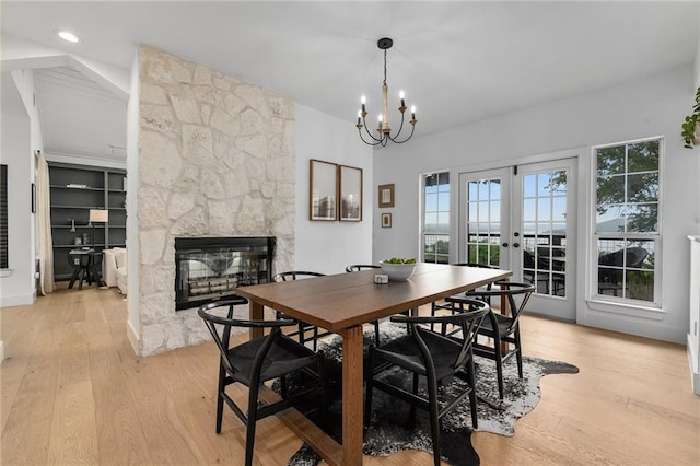 5224 Mccormick Mountain Dr, Austin, TX 78734 - dining space with a fireplace, healthy amount of natural light, light wood-style flooring, and vaulted ceiling