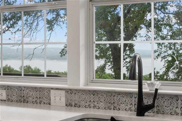 5224 Mccormick Mountain Dr, Austin, TX 78734 - kitchen view of decorative backsplash, a nearby body of water, and light countertops