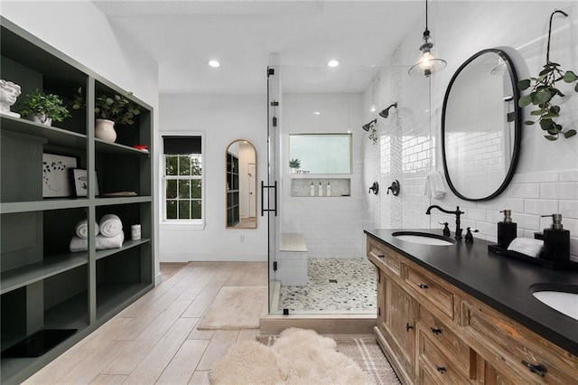 5224 Mccormick Mountain Dr, Austin, TX 78734 - bathroom featuring a stall shower, wood finished floors, double vanity, and plenty of natural light