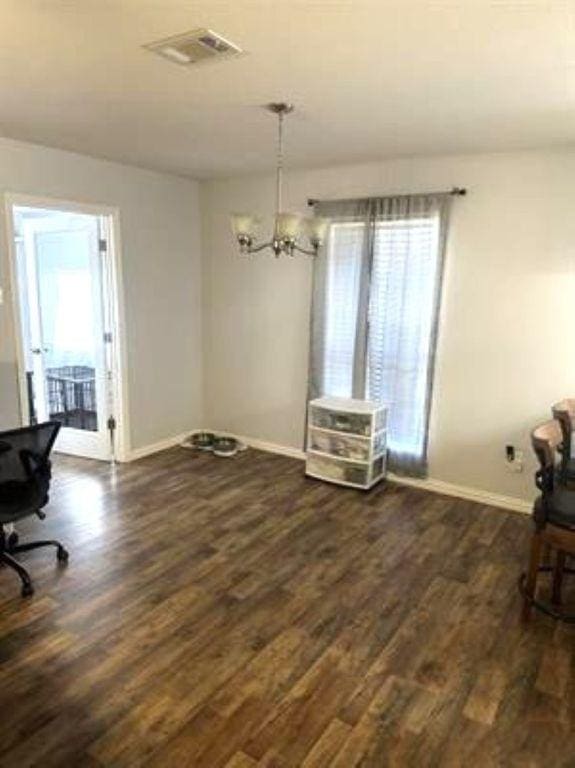 dining room with a wealth of natural light, visible vents, dark wood-style flooring, and baseboards