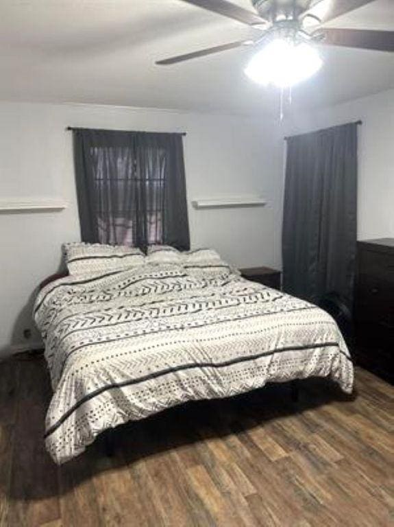 bedroom with a ceiling fan and wood finished floors