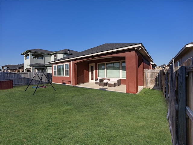back of house with an outdoor living space, a patio, a fenced backyard, and a lawn