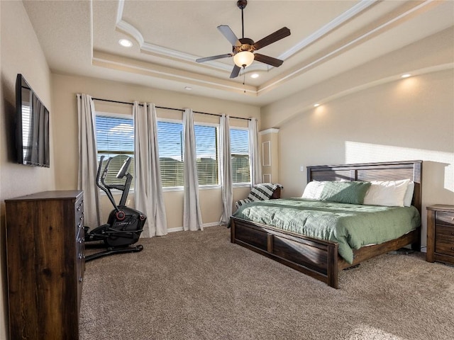 carpeted bedroom with a raised ceiling, arched walkways, recessed lighting, and a ceiling fan