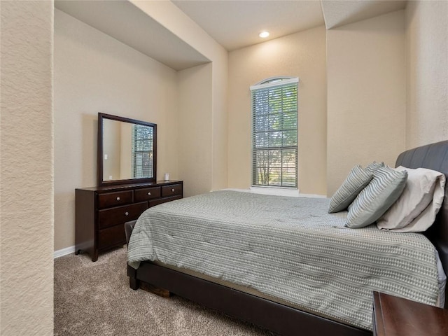 bedroom with carpet flooring and baseboards