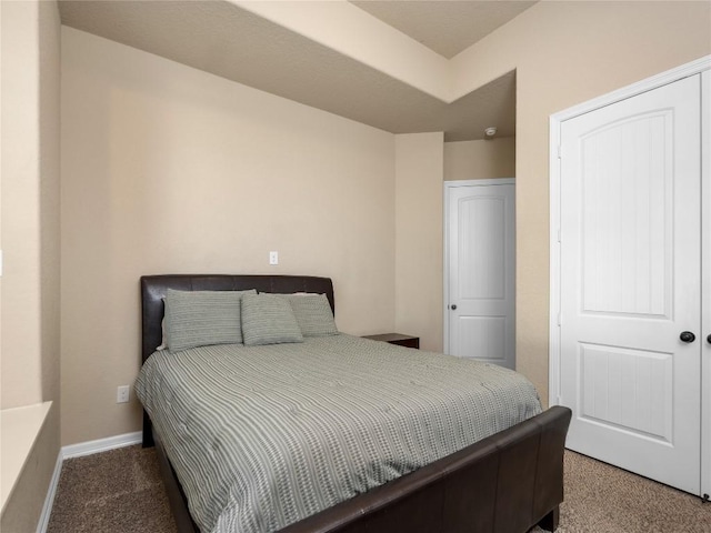 bedroom featuring baseboards and carpet