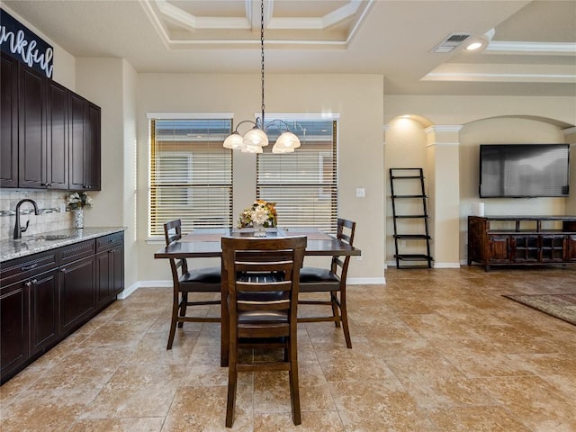 dining area featuring visible vents, baseboards, a notable chandelier, crown molding, and a tray ceiling