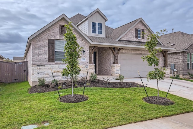 299 Grand Teton Dr, Kyle, TX 78640 - view of front of home with stone siding, concrete driveway, roof with shingles, and an attached garage