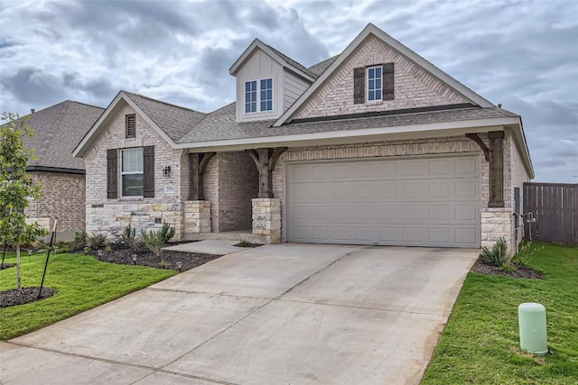 299 Grand Teton Dr, Kyle, TX 78640 - traditional-style home featuring stone siding, concrete driveway, a shingled roof, a garage, and covered porch