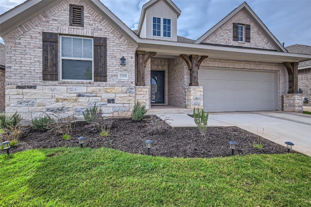 299 Grand Teton Dr, Kyle, TX 78640 - view of front facade featuring concrete driveway, an attached garage, and stone siding