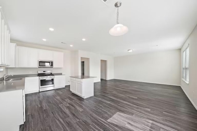 312 Singing Dove Way, Liberty Hill, TX 78642 - kitchen with stainless steel appliances, open floor plan, dark wood-style floors, a center island, and recessed lighting