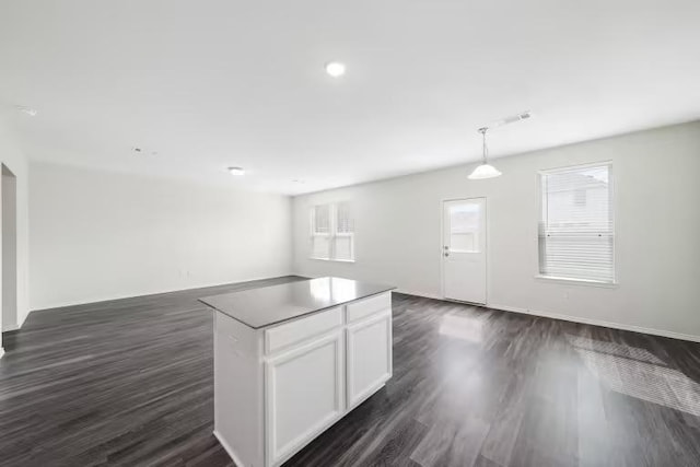 312 Singing Dove Way, Liberty Hill, TX 78642 - kitchen featuring open floor plan, dark wood finished floors, white cabinetry, a kitchen island, and pendant lighting